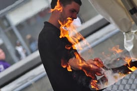 a man looking at a small potentially dangerous fire